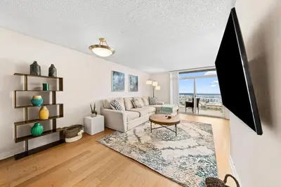 a living room with a couch and a table at Smoky Quartz -Marina View Spacious 3BR near Yacht Club in Los Angeles