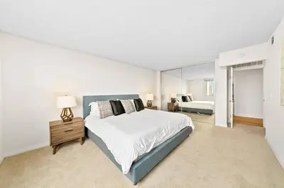 a large white bedroom with a bed and a mirror at Smoky Quartz -Marina View Spacious 3BR near Yacht Club in Los Angeles