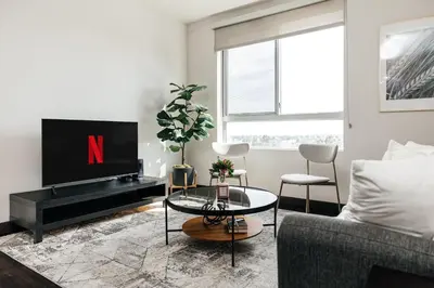 a living room with a tv and a couch at Stylish Vibes 1BD in WEHO in Los Angeles