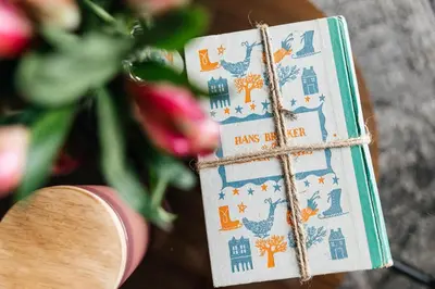 a book with drawings of houses and birds on it at Stylish Vibes 1BD in WEHO in Los Angeles
