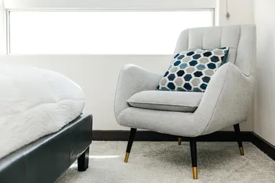 a bedroom with a chair next to a bed at Stylish Vibes 1BD in WEHO in Los Angeles