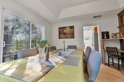 a dining room with a table and a large window at Oaks Garden in Thousand Oaks