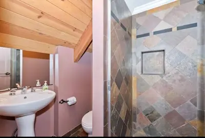 a bathroom with a sink and a shower at Arrowhead Lake Cabin pool table stunning views in Lake Arrowhead