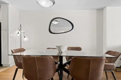 a dining room with a table and chairs and a mirror at Garnet Glow Full Ocean and Venice Beach view 3BR in Los Angeles