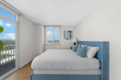 a bedroom with a bed and a large window at Garnet Glow Full Ocean and Venice Beach view 3BR in Los Angeles