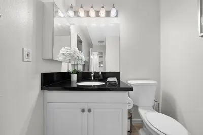 a bathroom with a sink and a toilet and a mirror at Garnet Glow Full Ocean and Venice Beach view 3BR in Los Angeles