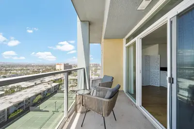 a balcony with two chairs and a view of a city at Garnet Glow Full Ocean and Venice Beach view 3BR in Los Angeles