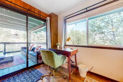 a home office with a desk and a window at Jackalope Lodge in Lake Arrowhead