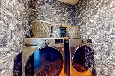 a washer and dryer in a room with wallpaper at Jackalope Lodge in Lake Arrowhead