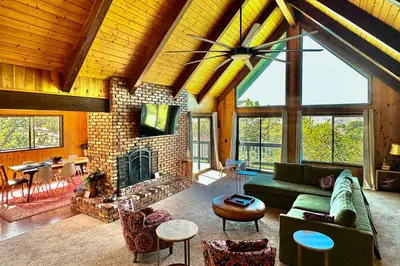 a living room with a couch and a fireplace at Jackalope Lodge in Lake Arrowhead