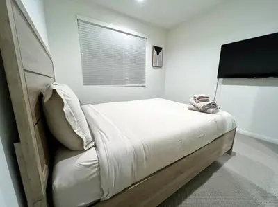 a white bedroom with a bed and a window at Modern Lux Home Near Disneyland And In The Heart Of OC! in Santa Ana