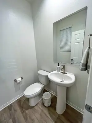 a white bathroom with a toilet and a sink at Modern Lux Home Near Disneyland And In The Heart Of OC! in Santa Ana