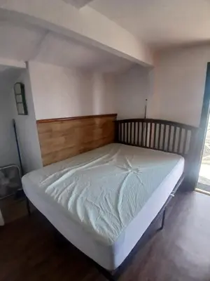 a bed in a room with a wooden headboard at The Village Cabins in Big Bear Lake