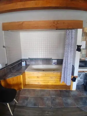 a bath tub in a kitchen with a tiled wall at The Village Cabins in Big Bear Lake