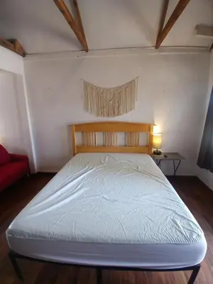 a bedroom with a bed with a white bedsheet at The Village Cabins in Big Bear Lake