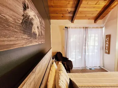 a room with a bed and a painting on the wall at The Ponderosa in Running Springs