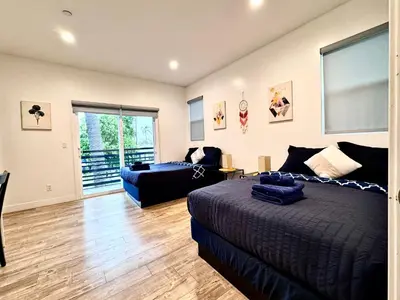 a bedroom with a bed and a living room at 4BR/4BR modern house at Mid-city in Los Angeles