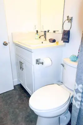 a bathroom with a white toilet and a sink at 4BR/4BR modern house at Mid-city in Los Angeles