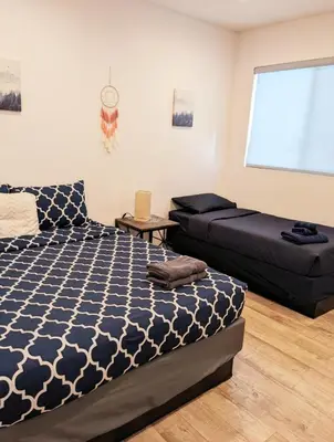 a bedroom with a bed and a couch at 4BR/4BR modern house at Mid-city in Los Angeles