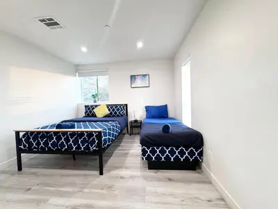 a room with two beds and a couch at Stylish 3 BR/3BR family house in Los Angeles