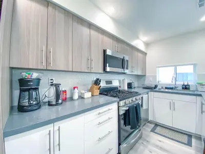 a kitchen with white cabinets and a stove top oven at Stylish 3 BR/3BR family house in Los Angeles