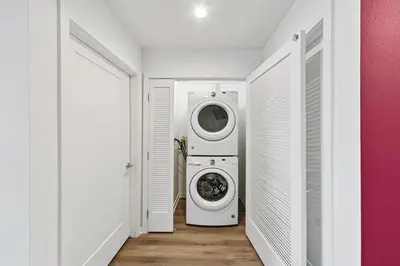 a laundry room with a washer and dryer at Fairfax District Chic City Oasis 2 BR Apt with Den 136 in Los Angeles
