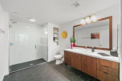 a bathroom with a shower and a toilet and a sink at Fairfax District Chic City Oasis 2 BR Apt with Den 136 in Los Angeles
