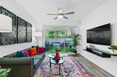 a living room with a couch and a tv at Fairfax District Chic City Oasis 2 BR Apt with Den 136 in Los Angeles