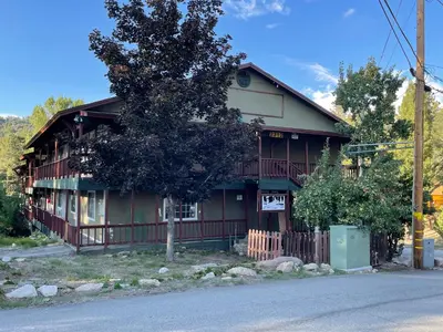 a house with a tree in front of it at Deep Creek in Arrowbear Lake