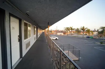 a balcony of a building with a car parked in a parking lot at Airport Stay Motel in Ontario