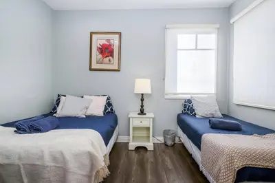 a bedroom with two beds and a window at Comfy 4BR home near Korea Town in Los Angeles
