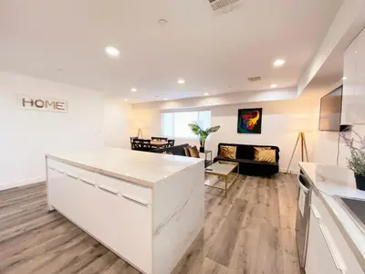 a kitchen and living room with a white counter top at Modern 3BR Home in Mid-City in Los Angeles