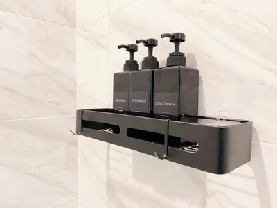 a black soap dispenser on a wall in a bathroom at Modern 3BR Home in Mid-City in Los Angeles