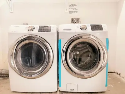 two washing machines are sitting next to each other at Modern 3BR Home in Mid-City in Los Angeles