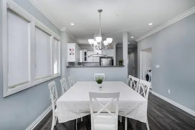 a dining room with a white table and chairs at Stylish 4 BR house near Korea Town (Central LA) in Los Angeles