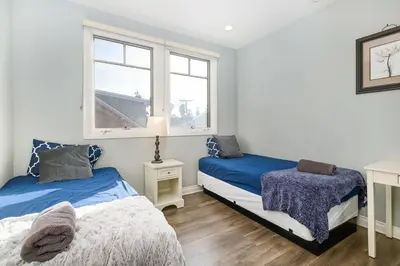 a bedroom with two beds and a window at Stylish 4 BR house near Korea Town (Central LA) in Los Angeles