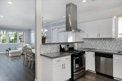 a kitchen with white cabinets and a stove top oven at Stylish 4 BR house near Korea Town (Central LA) in Los Angeles