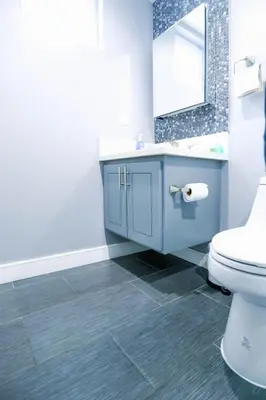 a bathroom with a blue sink and a toilet at Lucky Charm 4 Bedroom Mid-City Apartment in Los Angeles