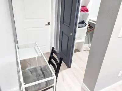 a closet with a blue door and a chair at Lucky Charm 4 Bedroom Mid-City Apartment in Los Angeles