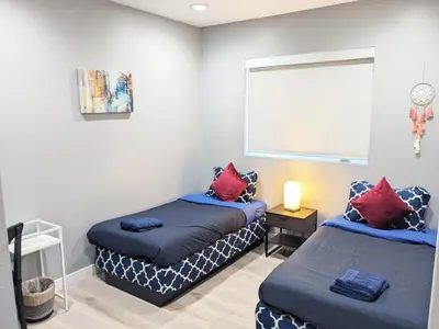 a bedroom with two beds and a window at Lucky Charm 4 Bedroom Mid-City Apartment in Los Angeles