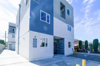 a house with a blue and white facade at Lucky Charm 4 Bedroom Mid-City Apartment in Los Angeles