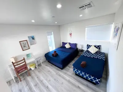 a living room with two beds and a couch at Cozy Chamber 3 BR Hollywood Townhouse in Los Angeles