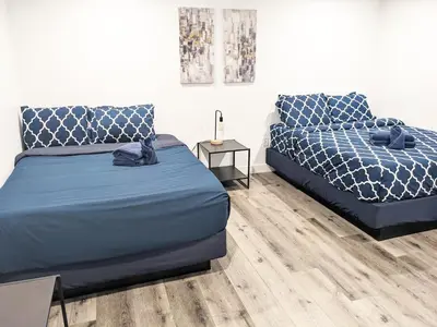 a bedroom with two beds and a side table at Wonderful 3 Bedroom Home Perfect for Getaway in Los Angeles