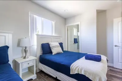 a bedroom with two beds and a window at 5 BR Home Near USC - Perfect Location in Los Angeles