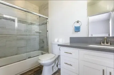 a bathroom with a toilet and a shower and a sink at Cheerful 5BR house with parking near USC in Los Angeles