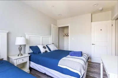 a bedroom with two beds with blue and white sheets at Cheerful 5BR house with parking near USC in Los Angeles