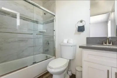 a bathroom with a shower and a toilet and a sink at Cheerful 5BR house with parking near USC in Los Angeles