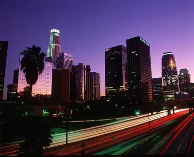 a city skyline at night with traffic on a freeway at Historic Downtown LA Loft - Urban Charm in Los Angeles