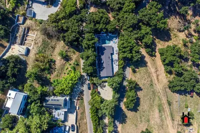 an aerial view of an estate with a house and trees at Resort Feel I Breathtaking Mountain Scenery I Pool in Malibu