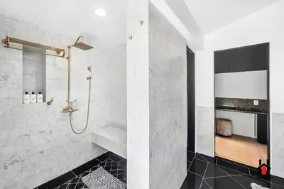 a bathroom with a walk in shower and a sink at Resort Feel I Breathtaking Mountain Scenery I Pool in Malibu